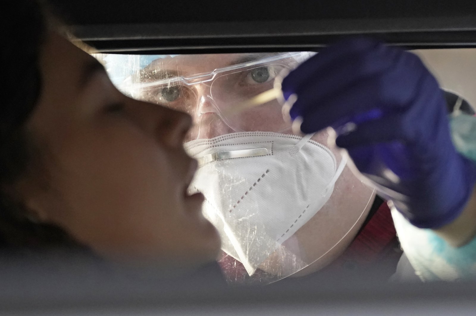 Zoey Marty is tested at the Utah National Guard's mobile testing site for COVID-19, in Salt Lake City, Utah, U.S., Nov. 17, 2020. (AP Photo)