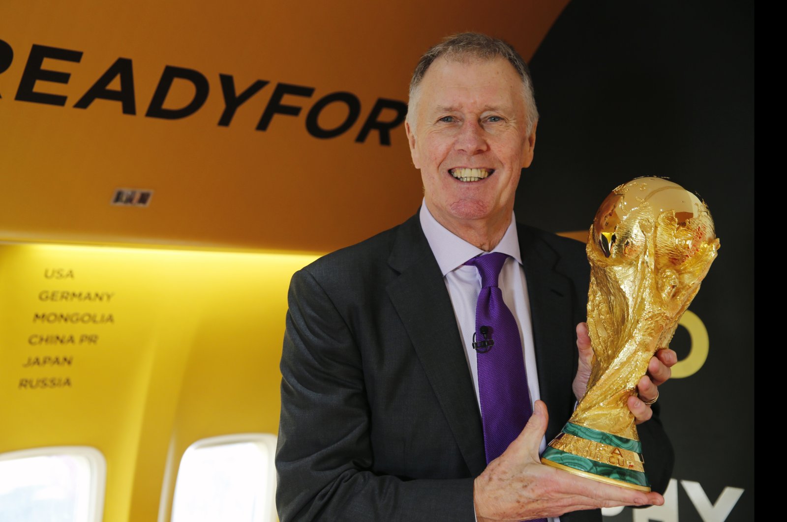 Geoff Hurst holds the FIFA World Cup trophy during the first leg of the soccer World Cup 2018 trophy tour at Stansted Airport, London, England, Jan. 22, 2018. (AP Photo)