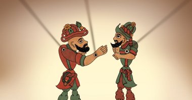 The puppets of Karagöz (L) and Hacivat are seen on the curtain. (iStock Photo)