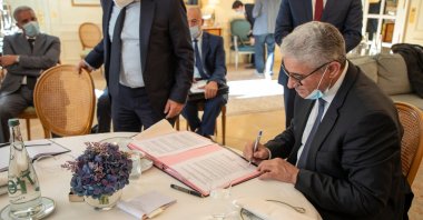 Libya's Interior Minister Fathi Bashagha signs the agreement with Idemia in Paris, France, Nov. 18, 2020. (Photo by Libya's Interior Ministry via AA)