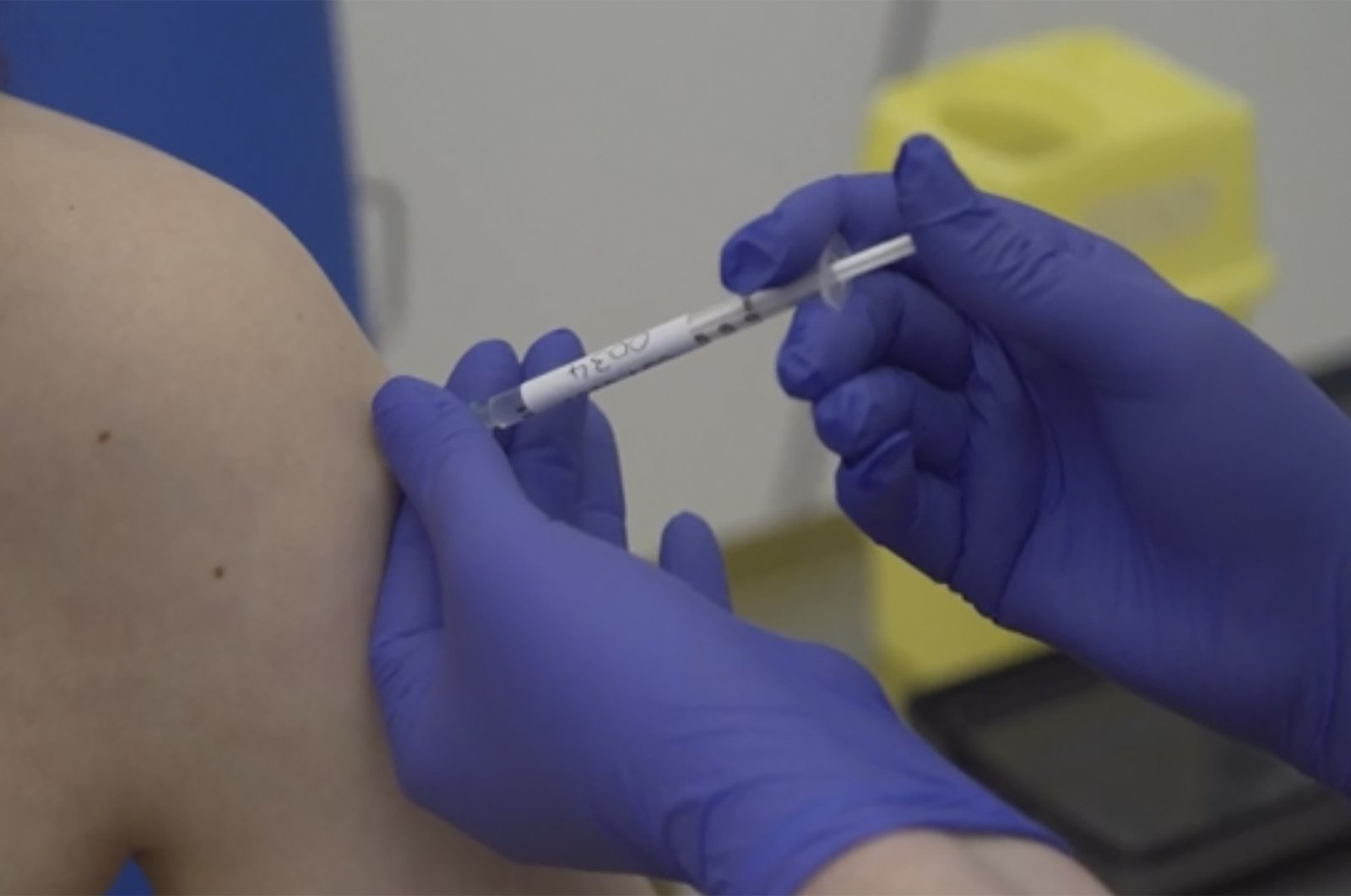 In this Thursday, April 23, 2020 file screengrab taken from a video issued by Britain's Oxford University, showing a person being injected as part of the first human trials in the U.K. to test a potential coronavirus vaccine, untaken by Oxford University in England. (Oxford University Pool via AP, File Photo)