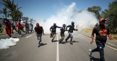 People run away from tear gas during the opposition Economic Freedom Fighters party's protest against alleged racism outside Brackenfell High School, Cape Town, South Africa, Nov. 20, 2020. (Reuters Photo)