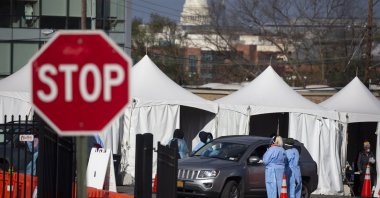 People in vehicles are tested with a swab at a drive-thru COVID-19 testing site operated by the District of Columbia, with the U.S. Capitol seen in the background, in Washington, the U.S., Nov. 18, 2020. (EPA Photo)