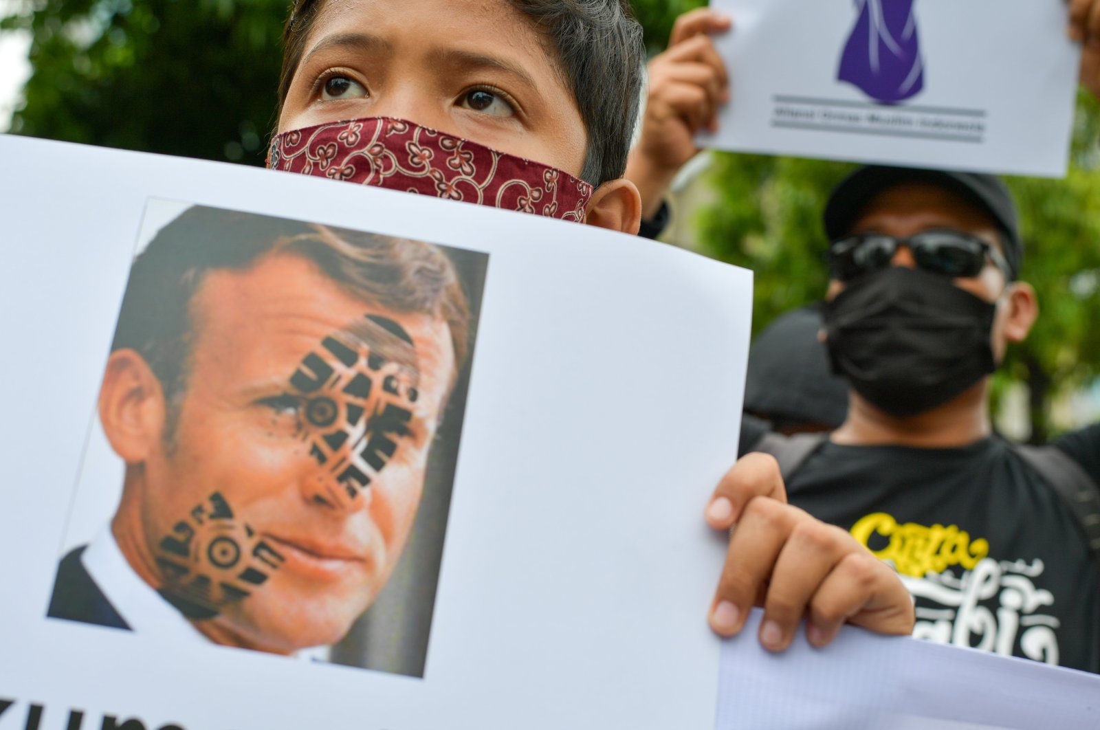 Muslim protesters display an image of French President Emmanuel Macron during an anti-France demonstration in Jakarta, Indonesia, Nov. 4, 2020. (AFP Photo)