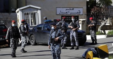 Lebanese policemen stand guard a detention center of Baabda courthouse compound were nearly 70 inmates broke out of a prison early Saturday after smashing their cell doors and attacking prison guards, in the Beirut southeastern suburb of Baabda, Lebanon, Saturday, Nov. 21, 2020. (AP Photo)