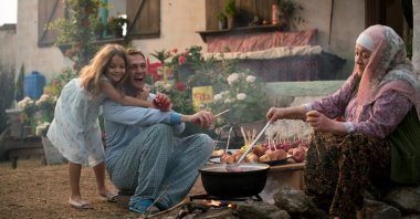 A still shot showing Ova (L), Memo (C) and grandmother Fatma in a scene from "7. Koğuştaki Mucize."