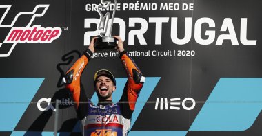 MotoGP rider Miguel Oliveira of Portugal celebrates on the podium after winning the MotoGP race of the Portuguese Motorcycle Grand Prix, the last race of the season, at the Algarve International Circuit near Portimao, Portugal, Nov. 22, 2020. (AP Photo)