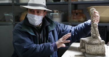 Professor Fikri Kulakoğlu holds the goddess statue found at the Kültepe archaeological site, Kayseri, central Turkey, Nov. 22, 2020. (AA PHOTO)