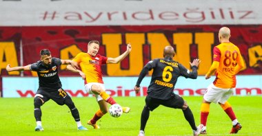 Muğdat Çelik (L) in action against Galatasaray's Martin Linnes (2nd L) during the match in Istanbul, Turkey, Nov. 24, 2020. (AA Photo)