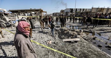 People inspect the scene of a car bomb in the northern Syrian town of al-Bab in Aleppo province, Nov. 24, 2020. (AFP Photo)