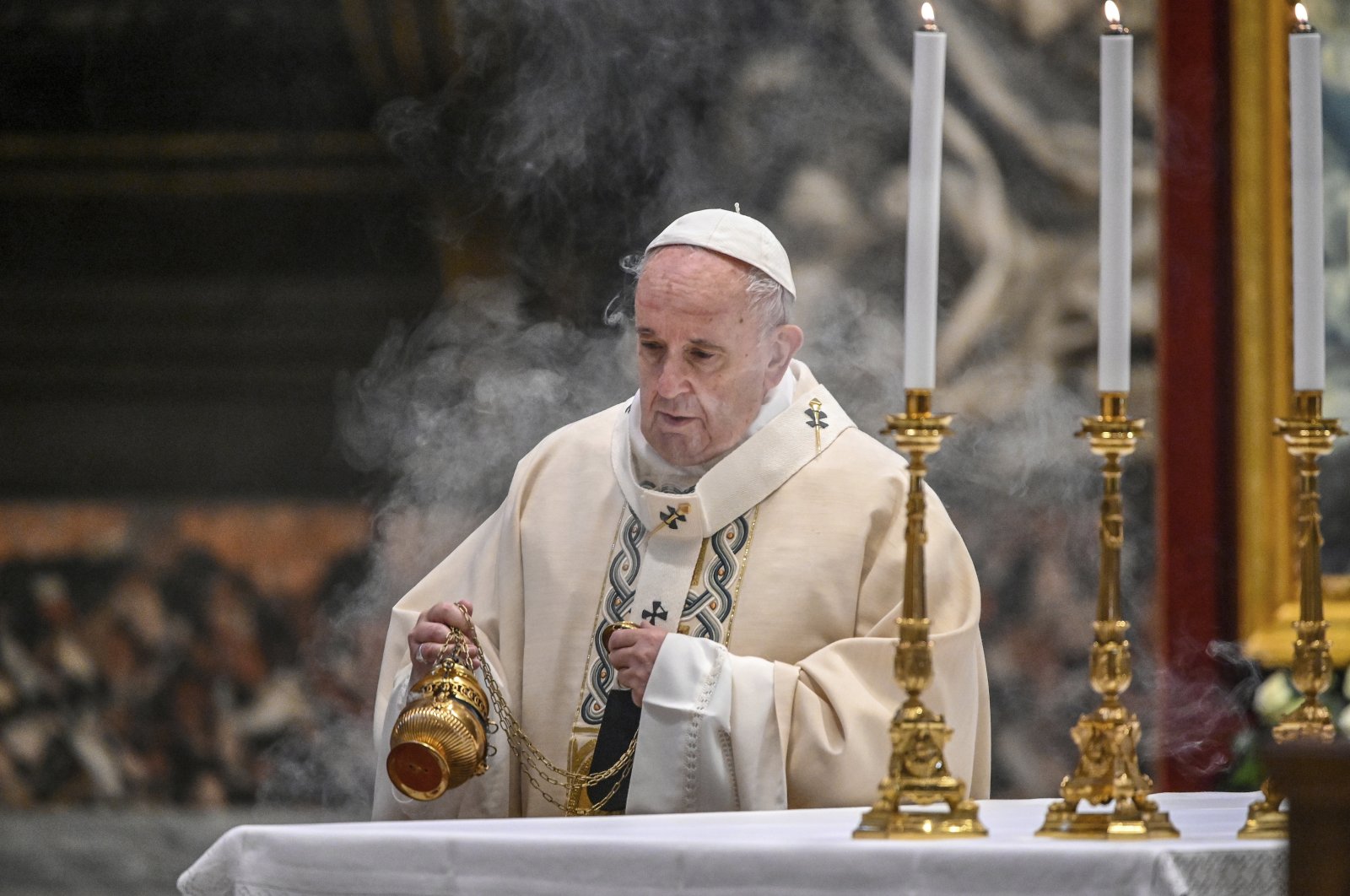 In this Nov. 22, 2020, file photo, Pope Francis incenses the altar as he celebrates Mass on the occasion of the Christ the King festivity, in St. Peter's Basilica at the Vatican. (AP Photo)
