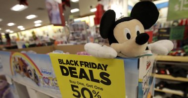 A sale sign is shown next to a Mickey Mouse doll at a Kohl's store in Colma, Calif., Friday, Nov. 29, 2019. (AP Photo)