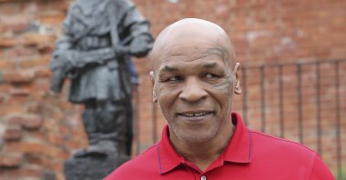 Mike Tyson stands in front of a memorial to Polish suffering during World War II, during a visit to Warsaw, Poland, June 27, 2019. (AP Photo)