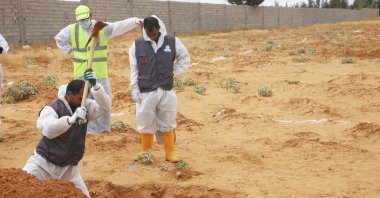 Libyan authorities dig out at a site of a suspected mass grave in the town of Tarhuna, Libya, June 23, 2020. (AP Photo)