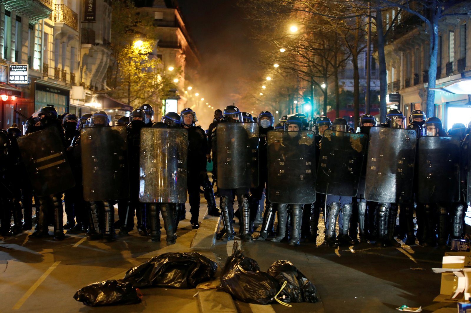 Compagnies Republicaines de Securite (CRS) riot police form a line during protests, Paris, France, Nov. 24, 2020. (Reuters Photo)