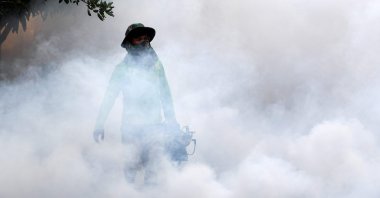 A man uses a mosquito fogging machine at a residential community in Phnom Penh, Cambodia, Nov. 19, 2020. (AFP Photo)
