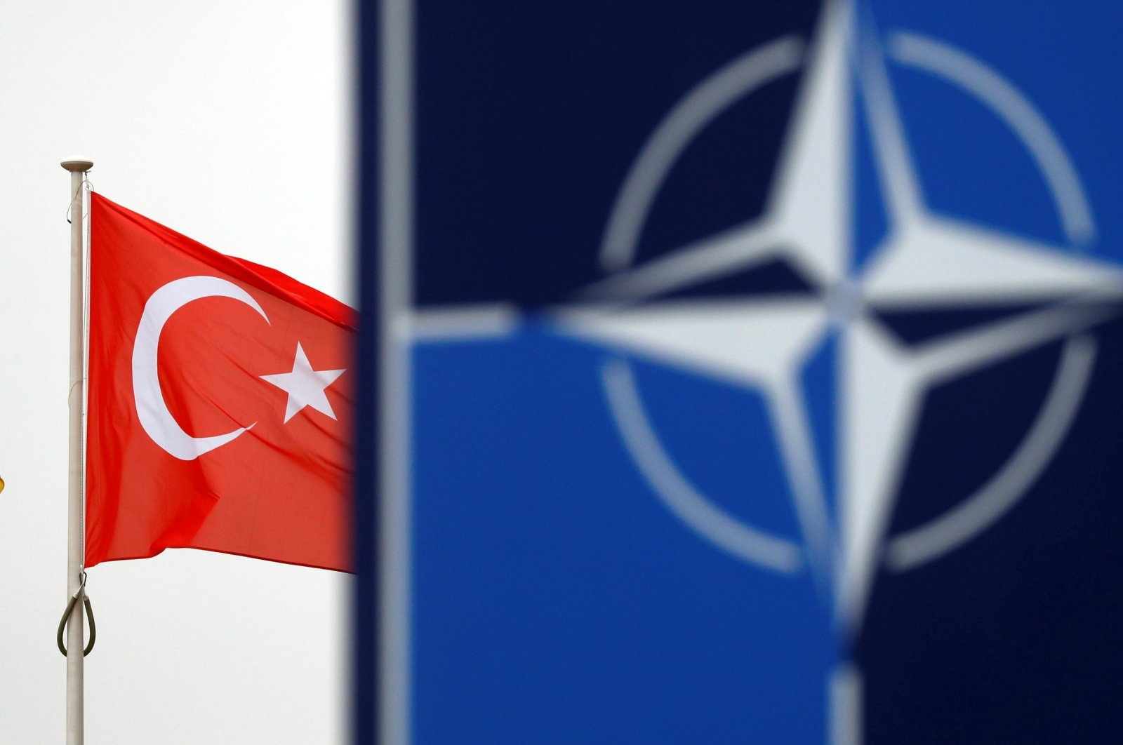 A Turkish flag flies next to the NATO logo at the alliance's headquarters in Brussels, Belgium, Nov. 26, 2019. (Reuters Photo)