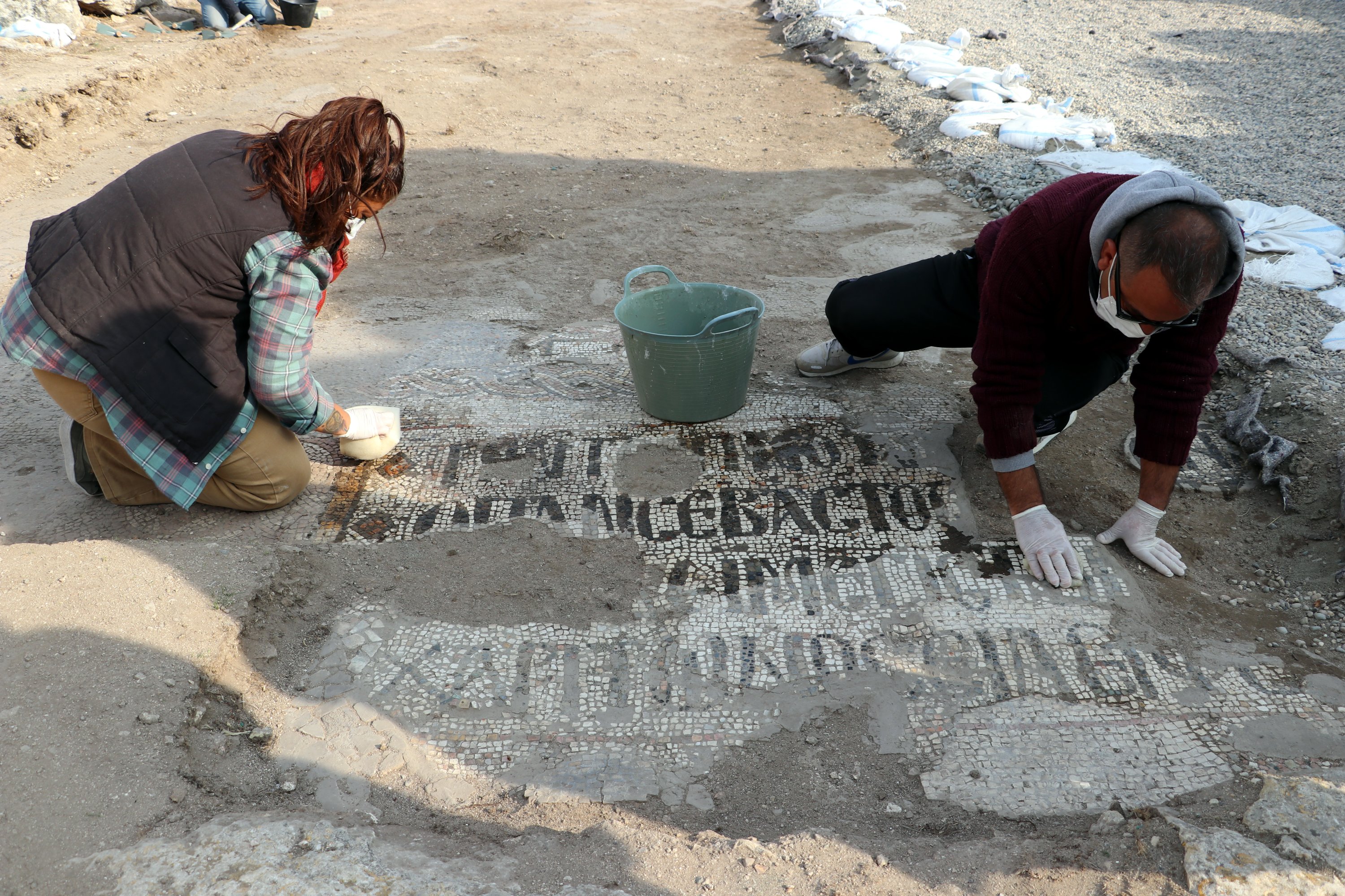 Two archaeologists uncover mosaics at the excavation of the Monastery of Saint Simeon Stylites the Younger, Hatay, southern Turkey, Nov. 26, 2020. (AA PHOTO)