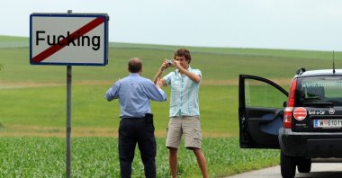This file photo shows tourists taking pictures of the road sign of the village of Fucking, some 35 kilometers north of Salzburg, Austria, June 18, 2008. (AFP Photo)
