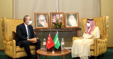Foreign Minister Çavuşoğlu (L) and his Saudi counterpart Farhan bin Abdullah Al Saud meet on the sidelines of the Organization of Islamic Cooperation's (OIC) Council of Foreign Ministers in Niger's Niamey, Nov. 27, 2020 (IHA Photo)
