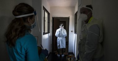 Doctors and nurses of the Special Continuity of Regional Assistance Unit (USCA) in collaboration with ARES 118 perform assistance and COVID-19 testing at home during the coronavirus pandemic emergency in Rome, Italy, Nov 17, 2020. (EPA Photo)