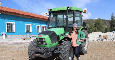Aynur Onur poses for a photo near her tractor in her hometown Burdur, southwestern Turkey, Nov. 27, 2020. (AA Photo)