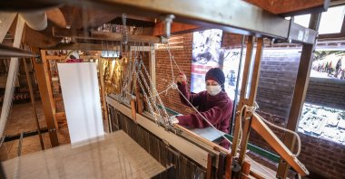 A weaver weaves fabric on the dobby jacquard loom at the Umurbey Silk Production and Design Center in Bursa, northwestern Turkey, Nov. 27, 2020. (AA PHOTO)