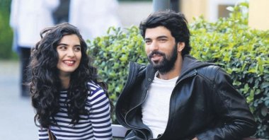 Actress Tuba Büyüküstün (L) and actor Engin Akyürek in a scene from "Kara Para Aşk."