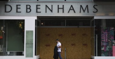 A man walks past a Debenhams store in the main shopping street Oxford Street, London, U.K., June 12, 2020. (AP Photo)