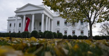 A ribbon hangs on the White House for World AIDS Day 2020, Dec. 1, 2020, in Washington. (AP Photo)