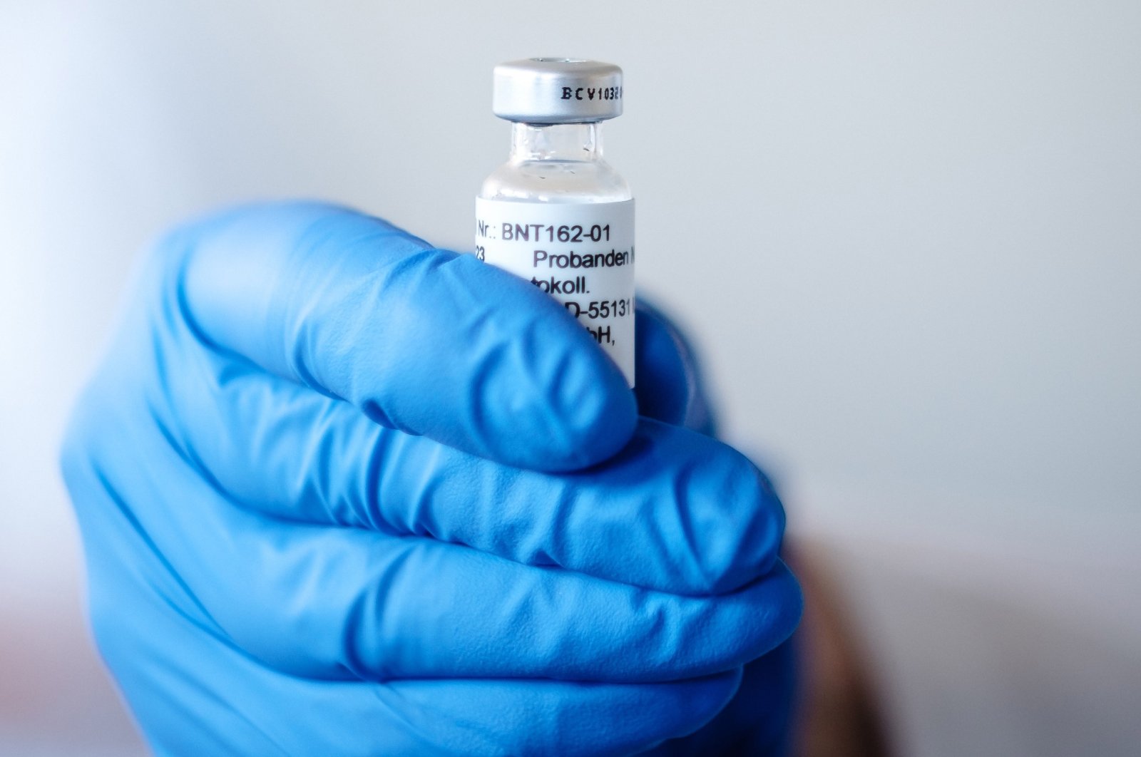 A hand holds an ampoule with BNT162b2, the mRNA-based vaccine candidate against COVID-19, in Mainz, Germany, in this undated photo. (BioNTech handout via EPA)
