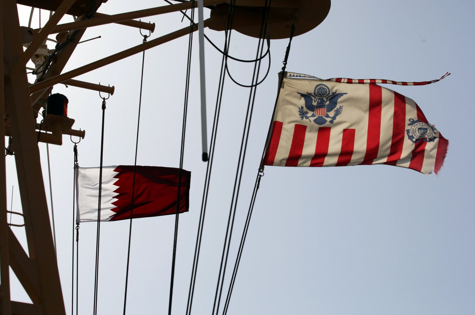 Qatari and U.S. Coast Guard flags flutter during a joint naval exercise by American and Qatari troops in the Arabian Gulf, Qatar, June 16, 2017. (Reuters Photo)