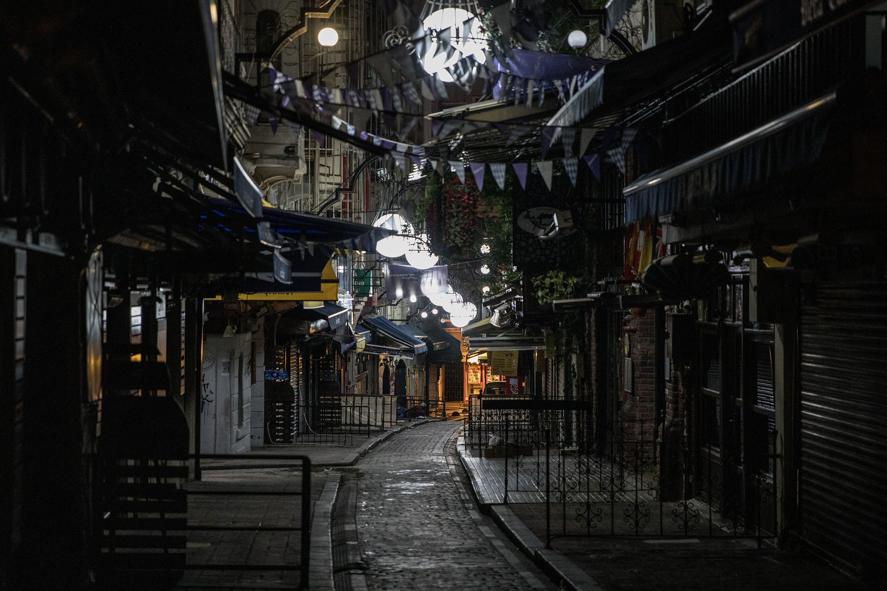 A normally busy restaurant street is seen empty as a new weekday curfew comes into effect in Istanbul, Turkey, Dec. 1, 2020.  (Photo by Getty Images)