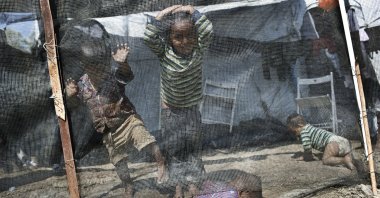 Children play inside the Moria refugee camp on the northeastern Aegean island of Lesbos, Greece, May 22, 2018. (AP Photo)