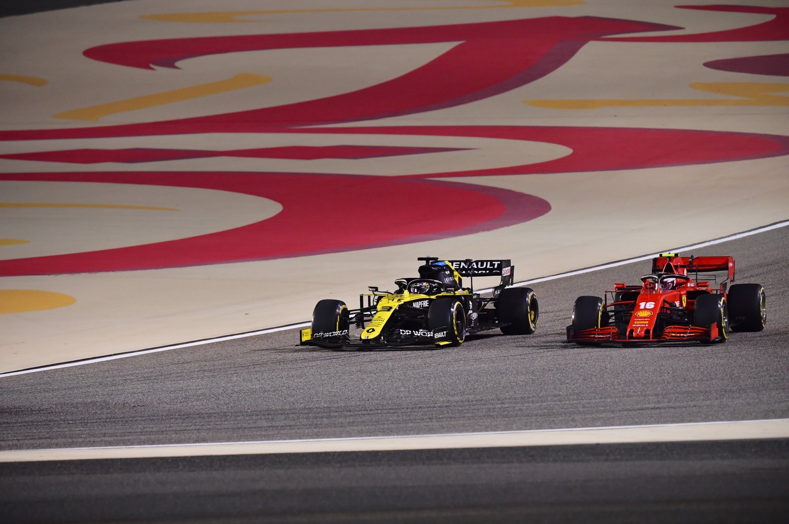 Daniel Ricciardo of Australia (L) and Charles Leclerc of Monaco in action during the Formula One Bahrain Grand Prix in Sakhir, Bahrain, Nov. 29, 2020. (AP Photo)