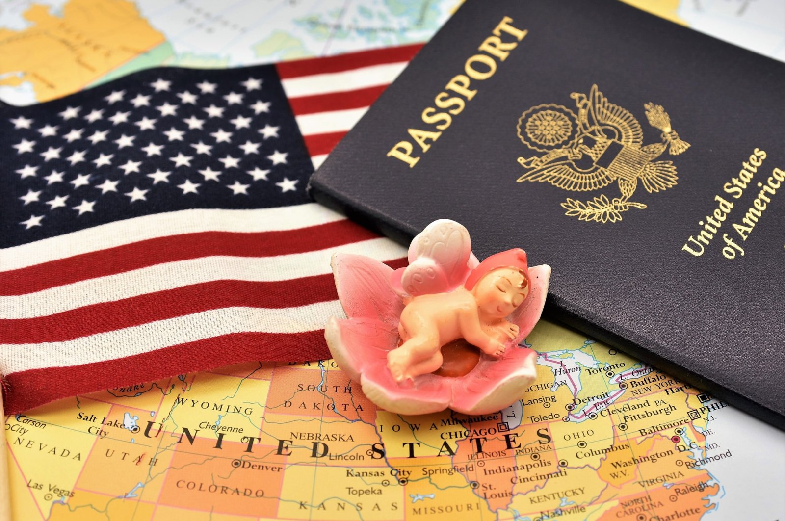 A newborn baby figurine, a U.S. flag and a passport placed together on the political map of America to depict the birthright to citizenship.(iStock Photo)