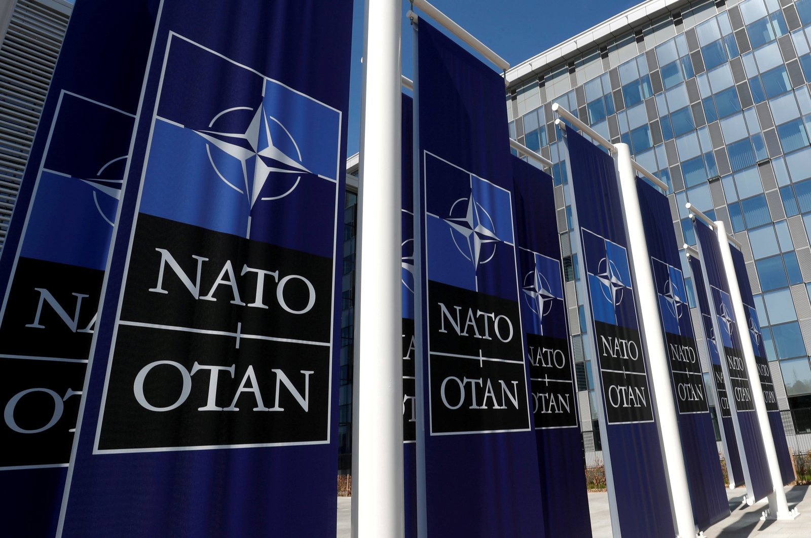 Banners displaying the NATO logo are placed at the entrance of the new NATO headquarters during the move to the new building, in Brussels, Belgium, April 19, 2018. (Reuters Photo)