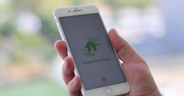 A man uses the Hayat Eve Sığar (Life Fits into Home), or HES, an app developed by the Health Ministry, in the capital Ankara, Turkey, Sept. 26, 2020. It has been the most-downloaded app in Turkey in 2020. (Shutterstock Photo)