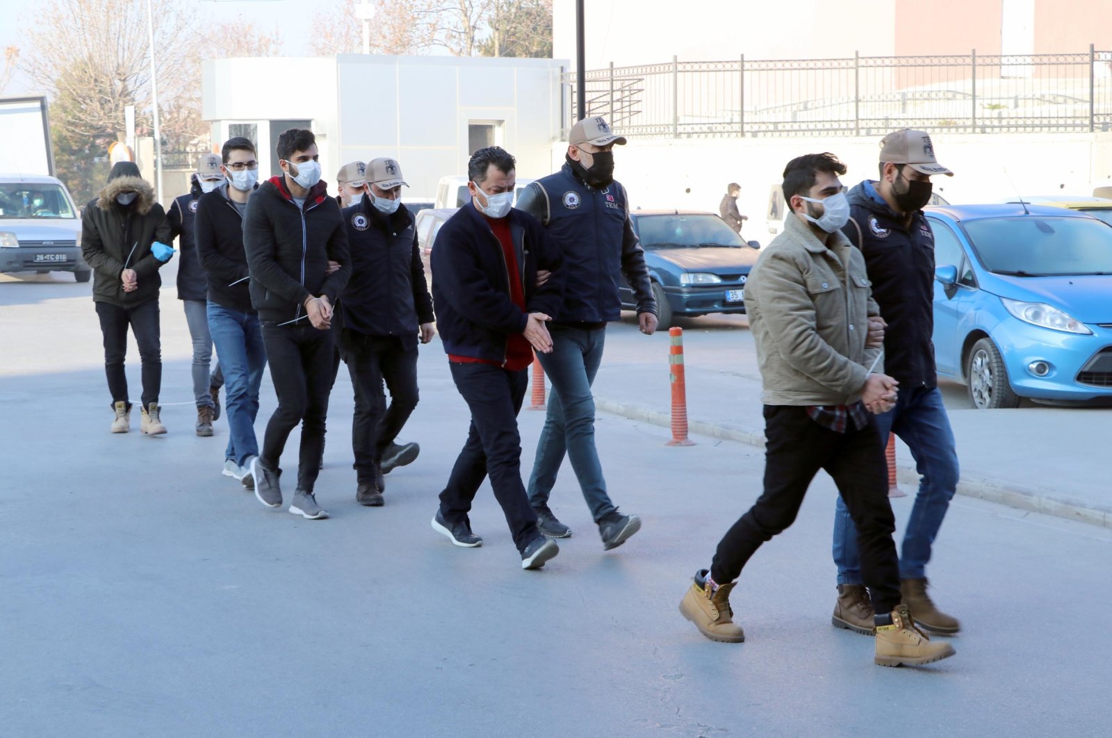 Police escort captured FETÖ suspects to the police station in Eskişehir, central Turkey, Dec. 4, 2020. (DHA Photo)