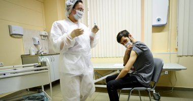 A nurse wearing a face mask proceeds to vaccination against the coronavirus by Sputnik V (Gam-COVID-Vac) vaccine at a clinic in Moscow on Dec. 5, 2020. (AFP Photo)