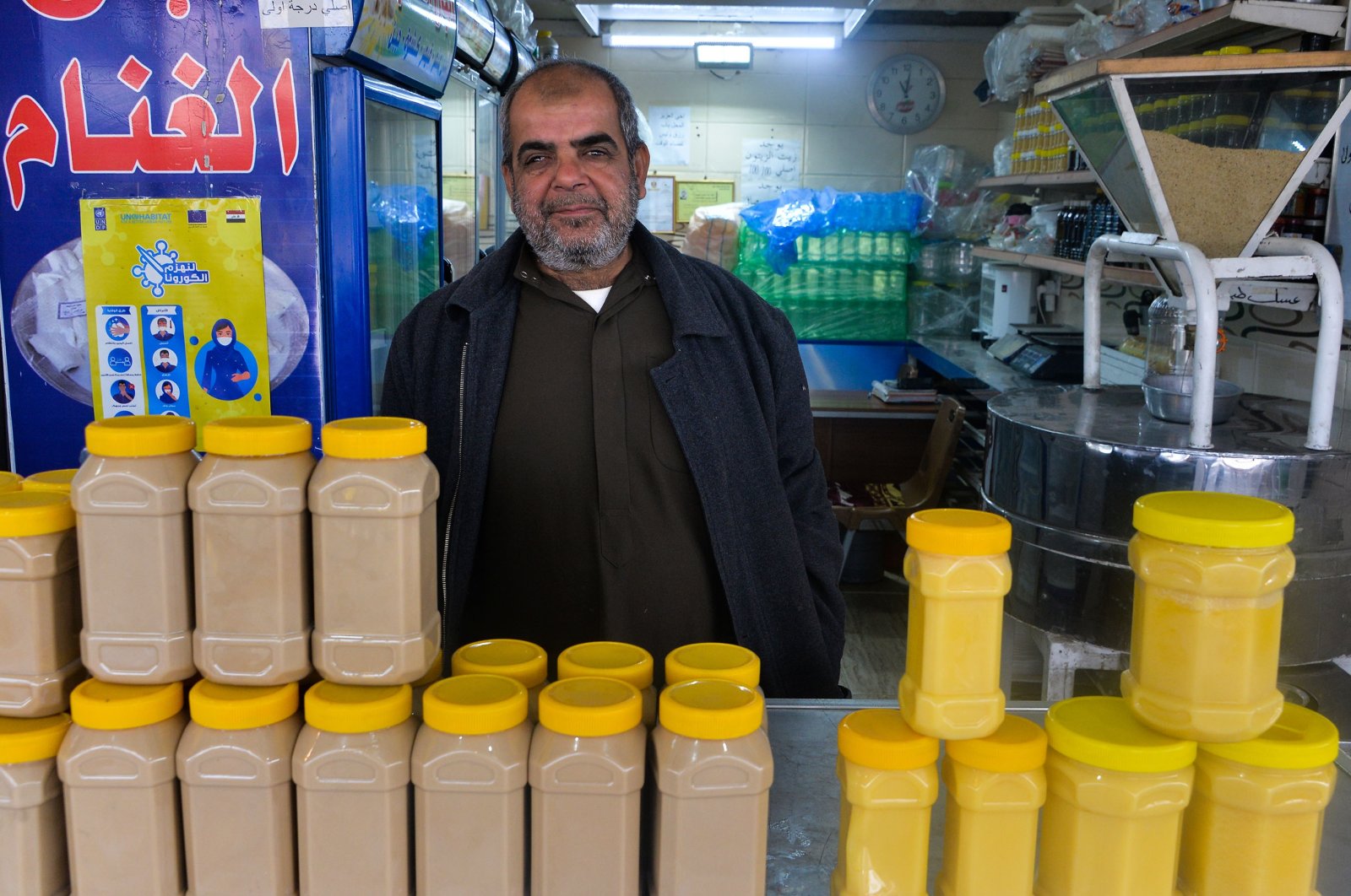 An Iraqi salesman poses for a picture in a shop at the Al-Bursa wholesale market in the northern city of Mosul, Iraq, Nov. 28, 2020. (Photo by Zaid AL-OBEIDI / AFP)