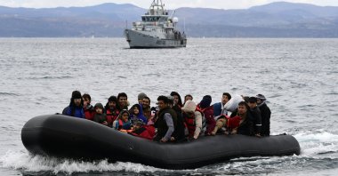 Migrants arrive with a dinghy accompanied by a Frontex vessel at the village of Skala Sikaminias, on the Greek island of Lesbos, after crossing the Aegean sea from Turkey, Feb. 28, 2020. (AP)