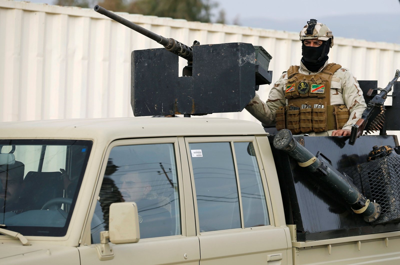 A member of Iraqi security forces rides a military vehicle during deployments in Sinjar, Iraq Dec. 1, 2020. REUTERS