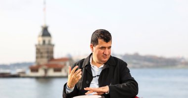 Bilal Göregen plays the darbuka in front of Istanbul's iconic Maiden's Tower, Turkey, Dec. 7, 2020. (AA Photo)