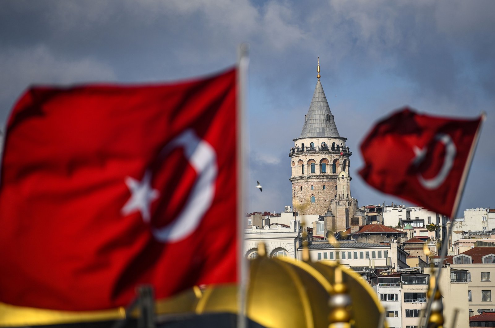 The iconic Galata Tower is pictured next to Turkish national flags during a weekend curfew aimed at curbing the spread of the COVID-19 pandemic, Istanbul, Turkey, DeC. 6, 2020.