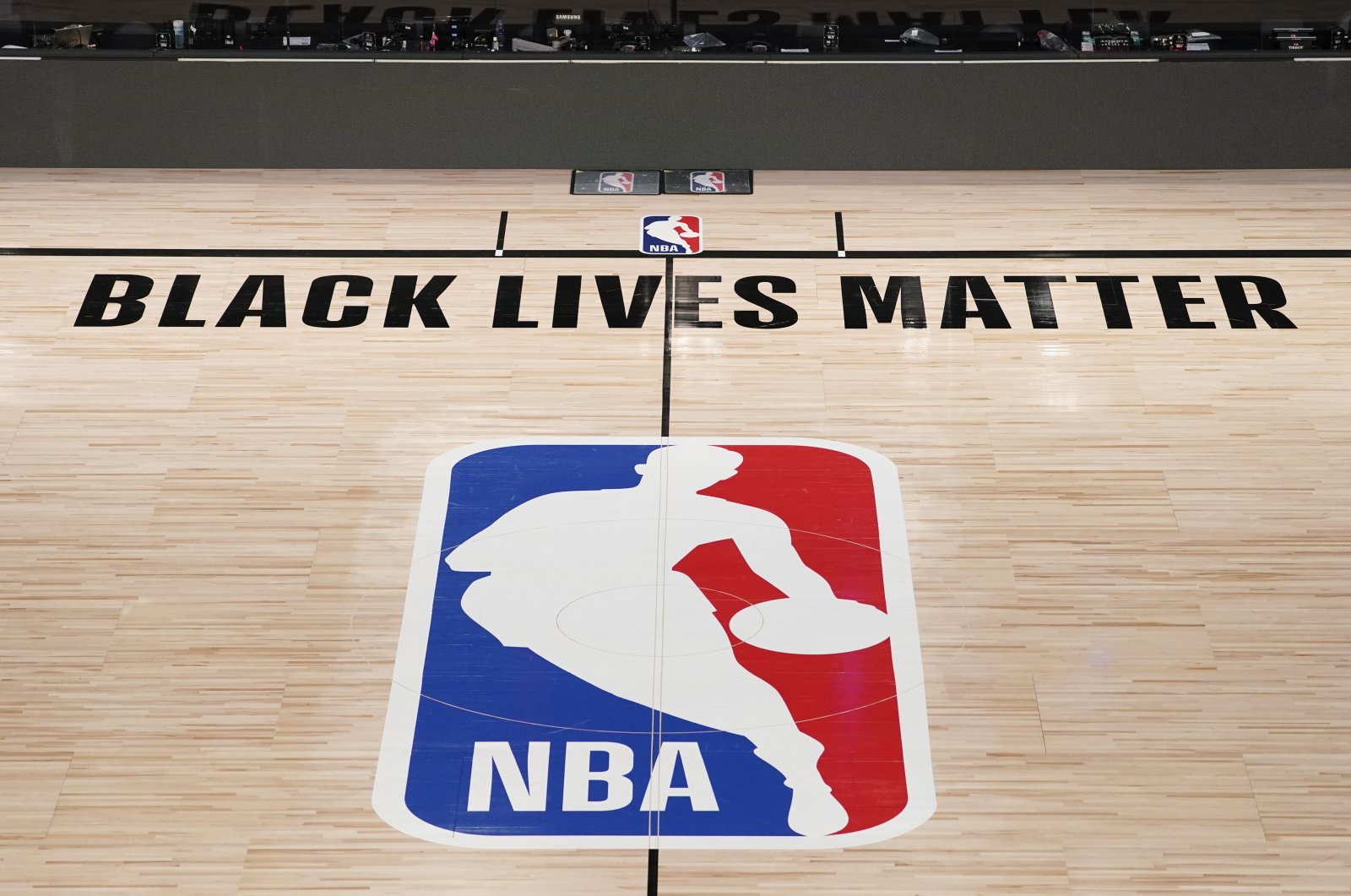NBA logo is displayed in an empty basketball arena in Lake Buena Vista, Florida, U.S., Aug. 28, 2020. (AP Photo)
