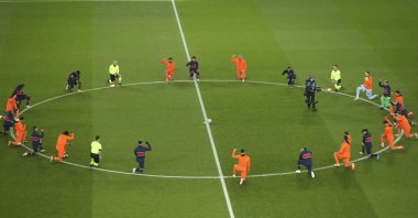 Players kneel in support of the Black Lives Matter campaign before the start of the Champions League group H soccer match between Paris Saint Germain and Istanbul Başakşehir at the Parc des Princes stadium in Paris, France, Dec. 9, 2020. (AP Photo)