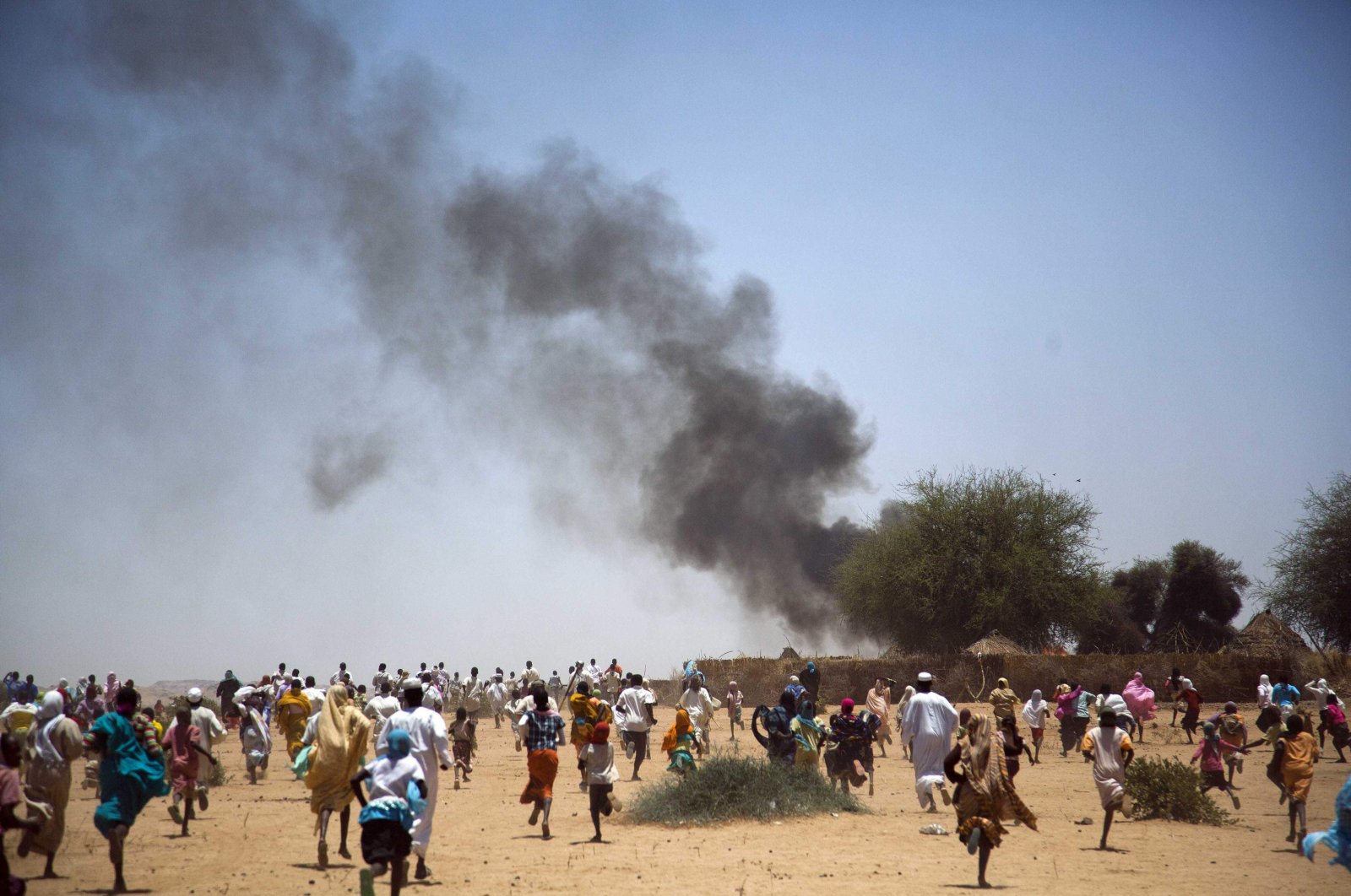Villagers run away with their belongings from a fire in Kuma Garadayat, a village located in North Darfur, Sudan, May 19, 2011. (Reuters Photo)