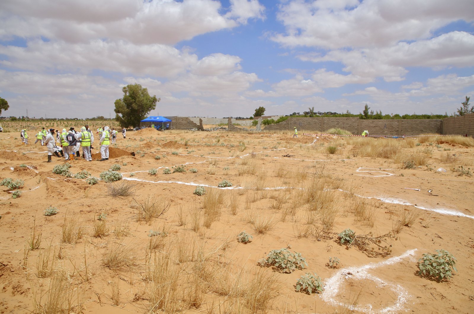 Libyan Ministry of Justice employees dig at the site of a suspected mass grave in the town of Tarhuna, Libya, June 23, 2020. (AP Photo)