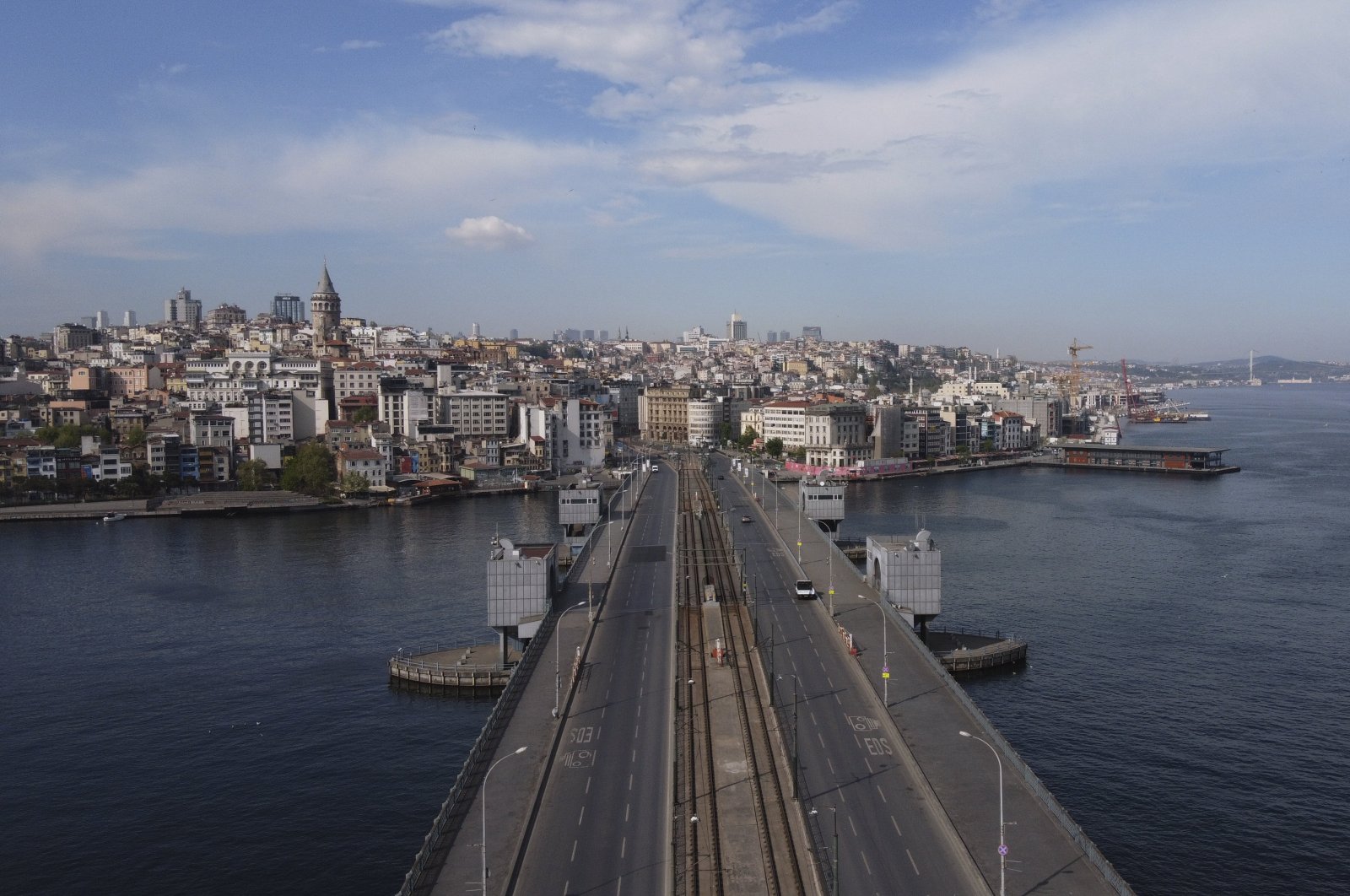 An aerial view of Galata Bridge, deserted due to the coronavirus lockdown, over the Golden Horn leading to the Bosporus, right, separates Asia and Europe in Istanbul, Turkey, May 1, 2020. (AP Photo)